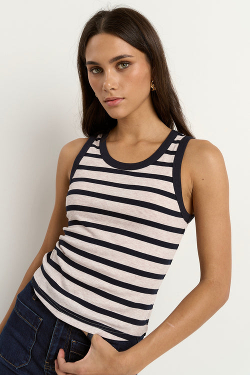 model wears a navy white stripe tank with blue jeans