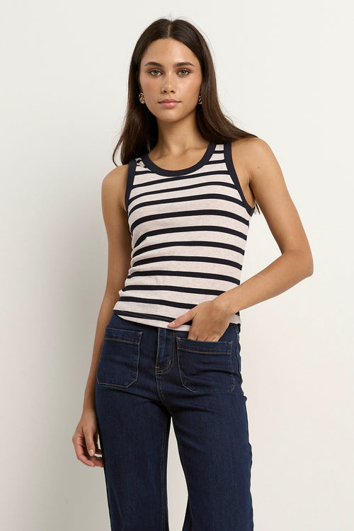 model wears a navy white stripe tank with blue jeans