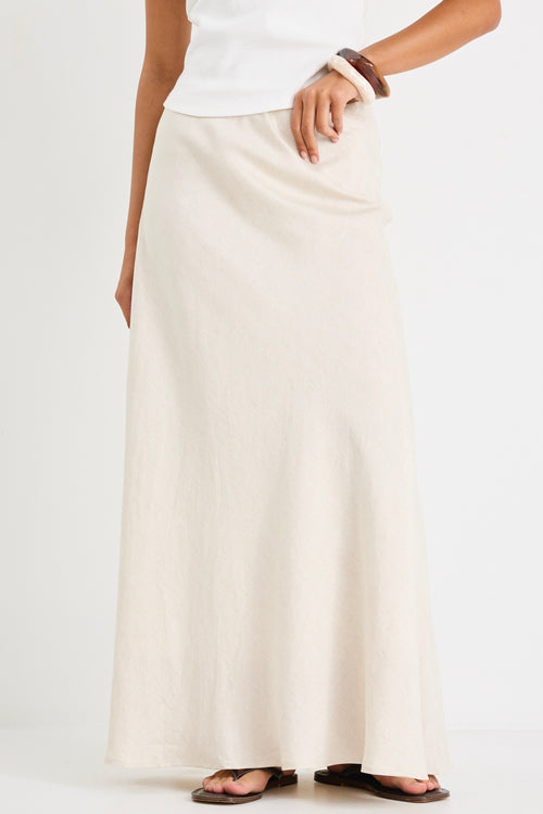 model wears white tank top and a natural linen skirt