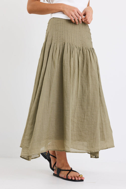model wearing khaki linen skirt and white top