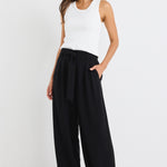 model wears a wide leg black pant