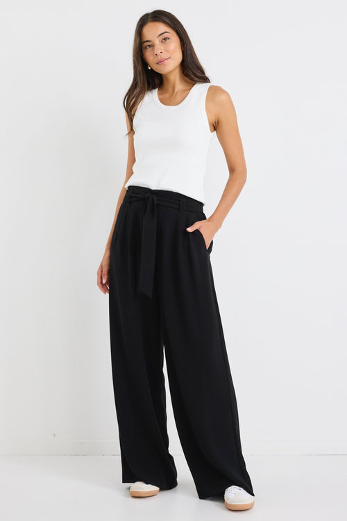 model wears a wide leg black pant