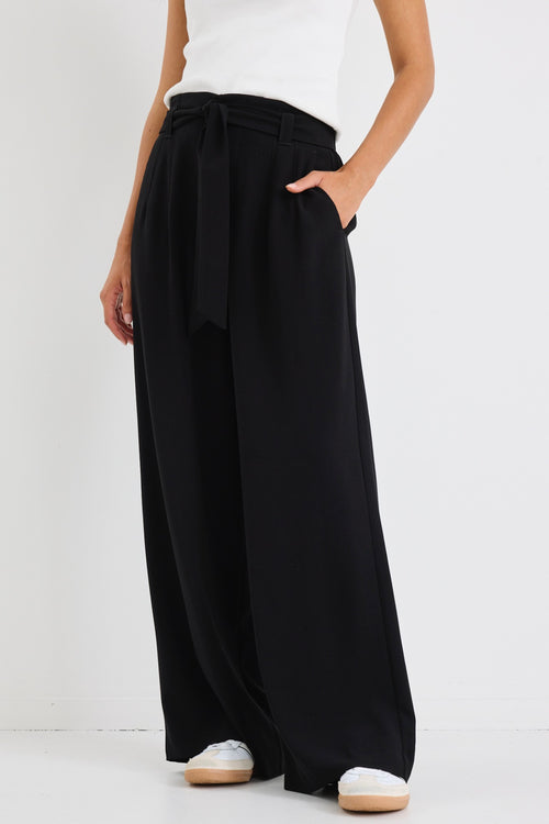 model wears a wide leg black pant