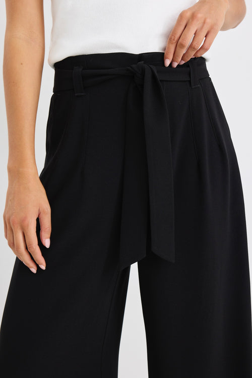 model wears a wide leg black pant