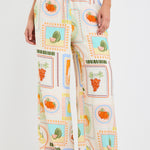 model wears a multi coloured fruit print draw string pant