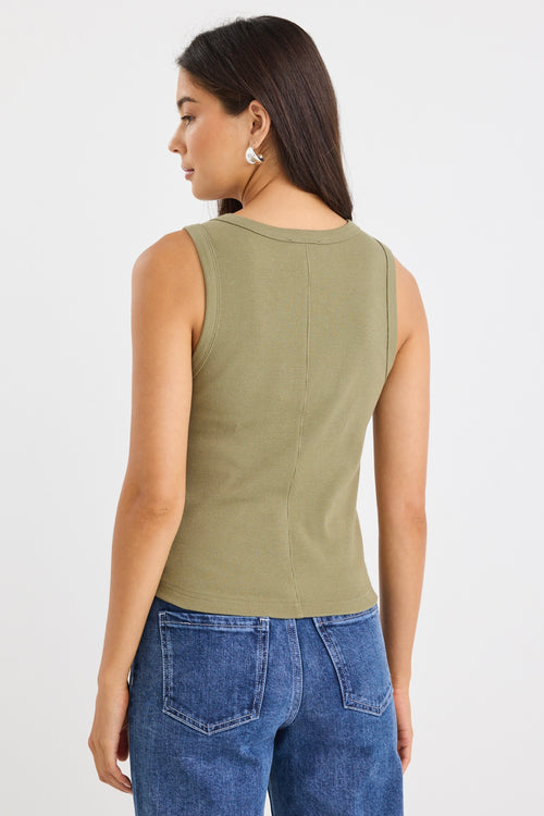 model wears a khaki green ribbed tank top with dark blue jeans