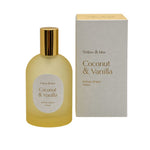 A bottle of Willow & Mae Coconut & Vanilla Room Spray next to its packaging box, both in a soft yellow and beige color scheme with gold accents.