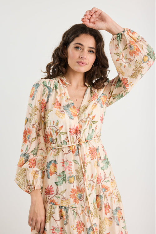 Woman wearing a floral dress against a white background