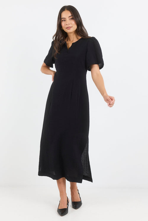 Woman wearing a black dress on a white background