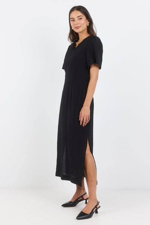 Woman wearing a black dress on a white background