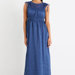 Woman wearing a navy ruched maxi dress