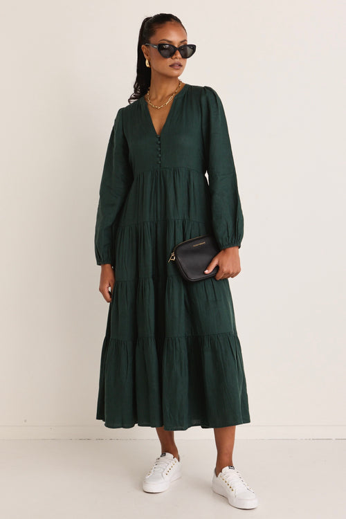 model wears a green maxi dress