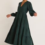 model wears a green maxi dress