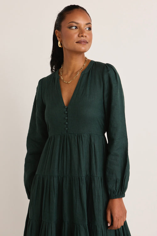 model wears a green maxi dress