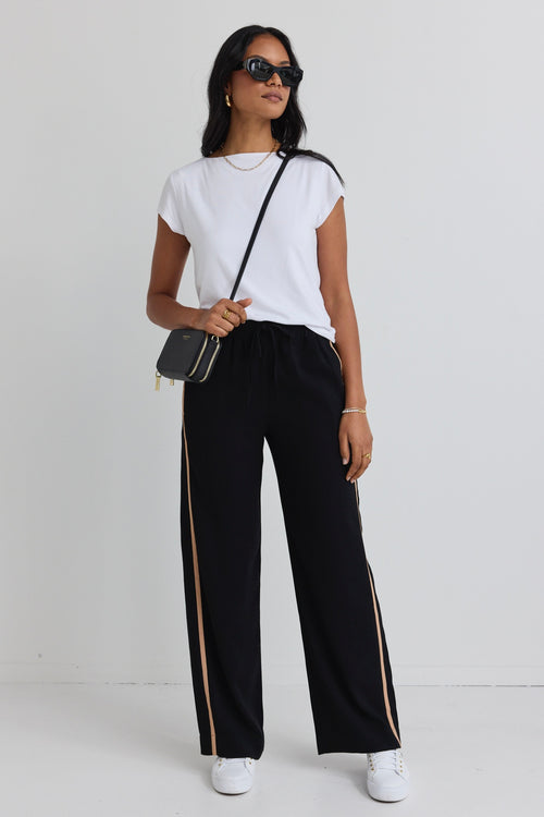 model wears black natural stripe pant