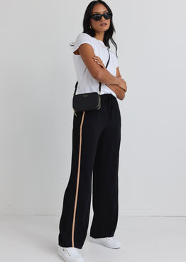 model wears black natural stripe pant