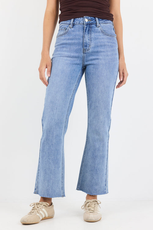 Person wearing light blue jeans on a white background