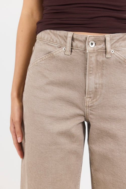 Beige jeans worn by a person on a white background