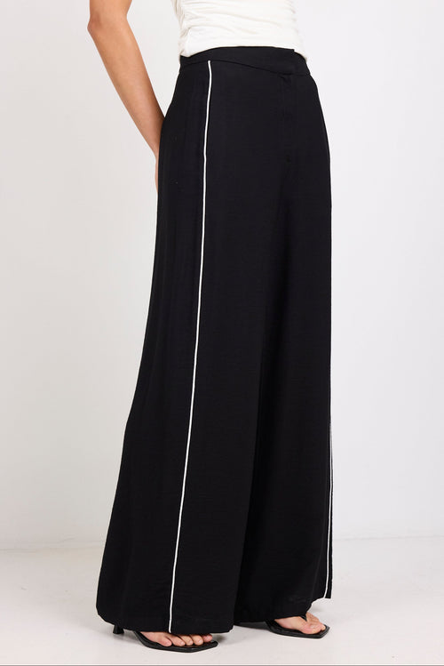Black wide-leg pants with a white stripe on a white background