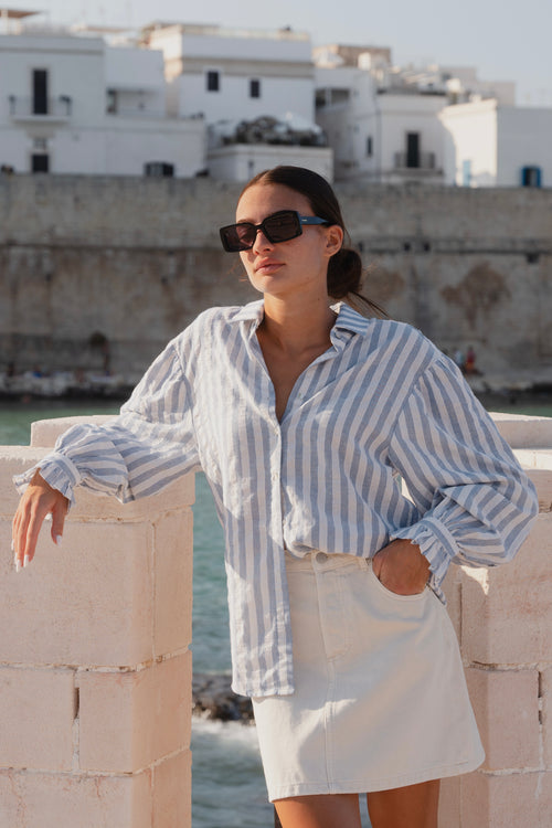 model wears a blue stripe shirt