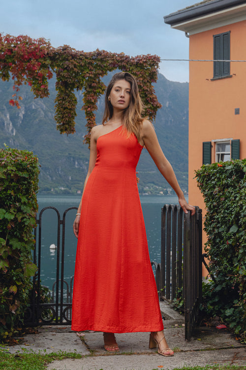 model wears a one shoulder red maxi dress