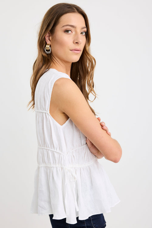 model wearing white ruched top with tie details 