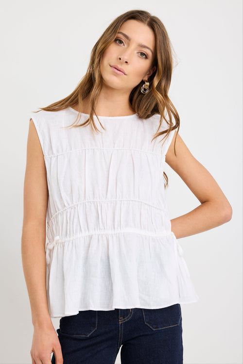 model wearing white ruched top with tie details 
col_pattern