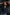 Woman posing with hands behind head against classical architecture