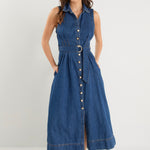 Model wears a sleeveless denim midi dress with white sneakers