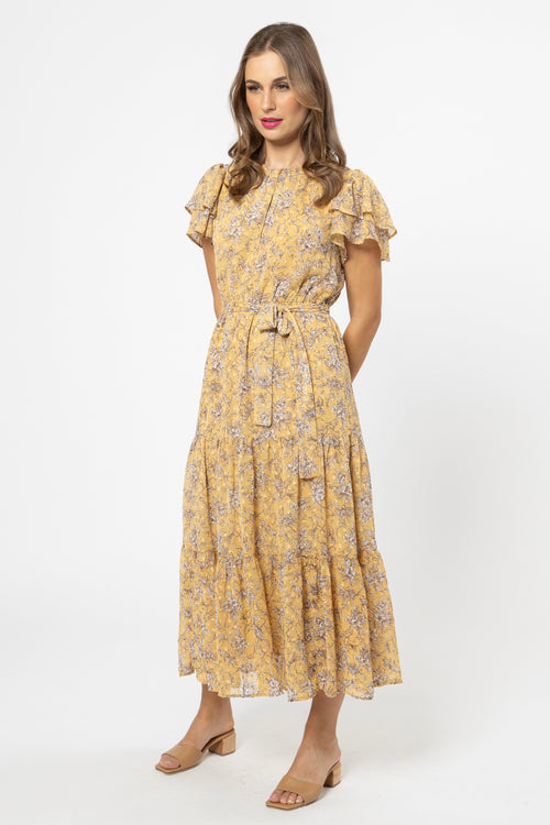 model wears a yellow floral maxi dress