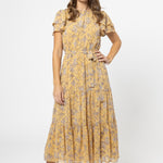 model wears a yellow floral maxi dress