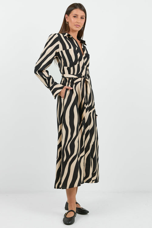 Woman wearing a zebra print dress on a white background