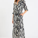 Woman wearing a zebra print dress on a white background