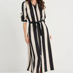 Woman wearing a black and white striped dress on a white background