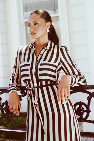 model wears a black stripe shirt dress