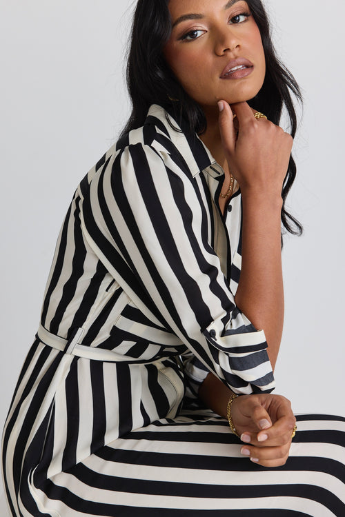 model wears a black and white stripe midi dress