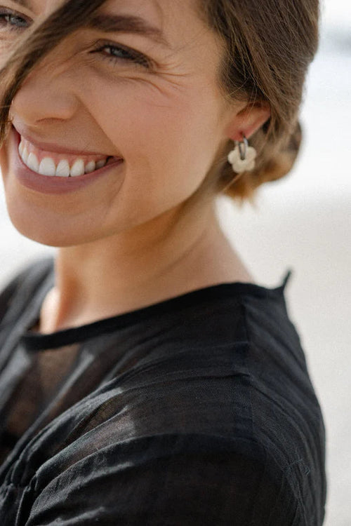 Woman wearing a black top with a blurred background