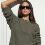 khaki knit jumper and blue jeans