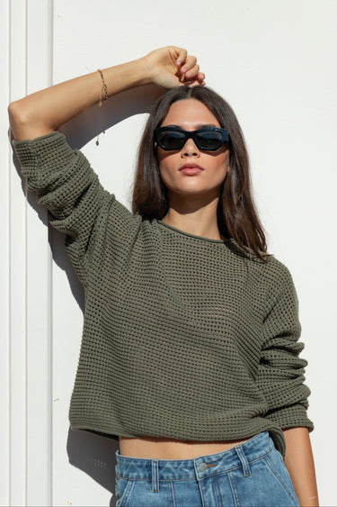 khaki knit jumper and blue jeans