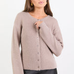 Woman wearing a beige cardigan on a white background