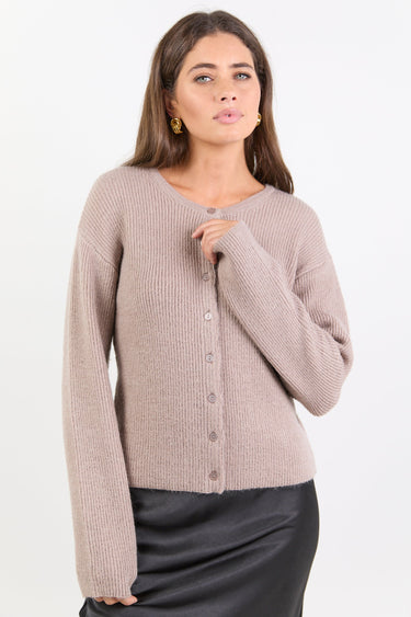 Woman wearing a beige cardigan on a white background