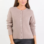 Woman wearing a beige cardigan on a white background