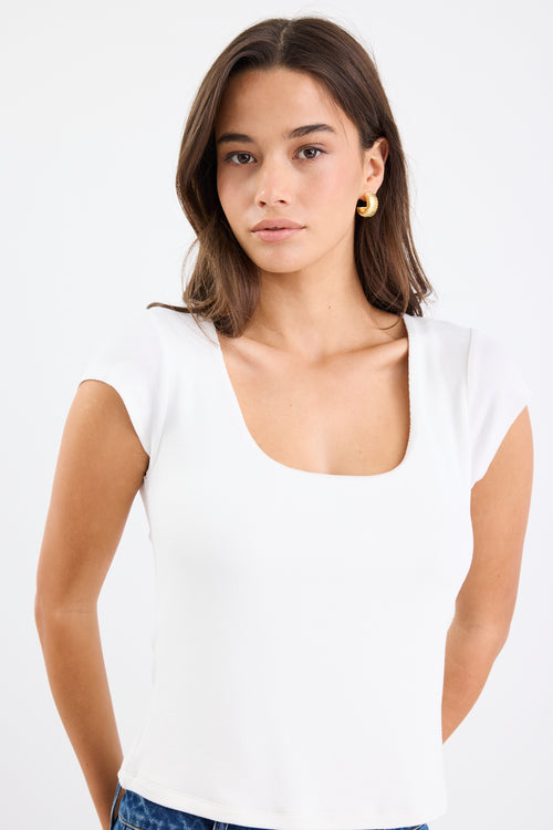 white rib fitted top with blue jeans