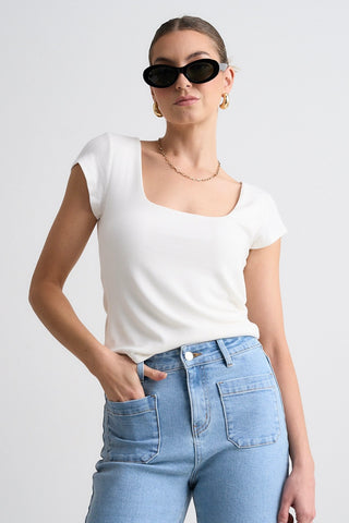 model wears a white tee