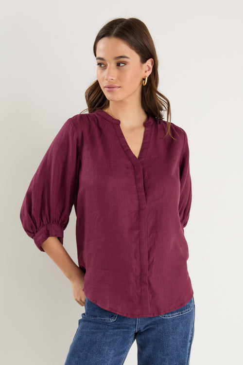 burgundy blouse on model 