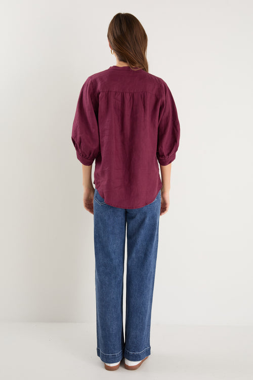 burgundy blouse on model 