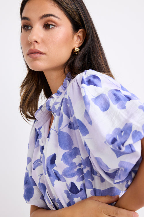 model wears a blue and white floral mini dress