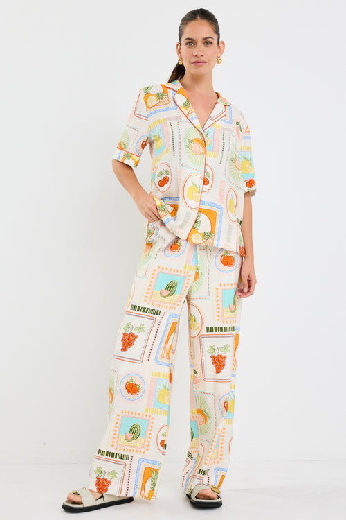 model wears a multi coloured fruit print draw string pant