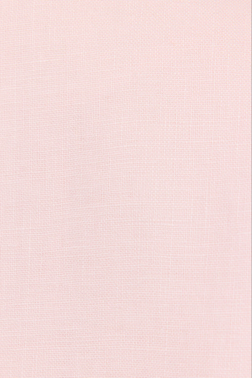 A close-up of a light pink textured fabric with a subtle woven linen-like pattern.