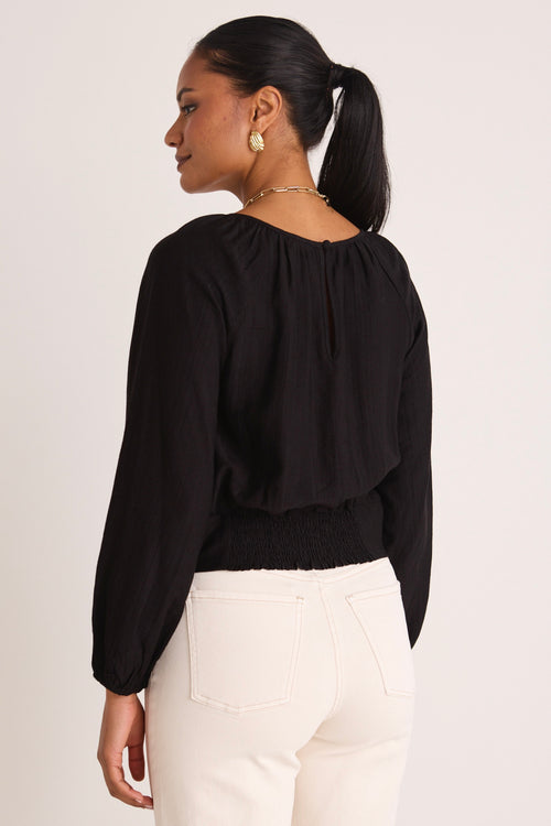 Model wears a black blouse 